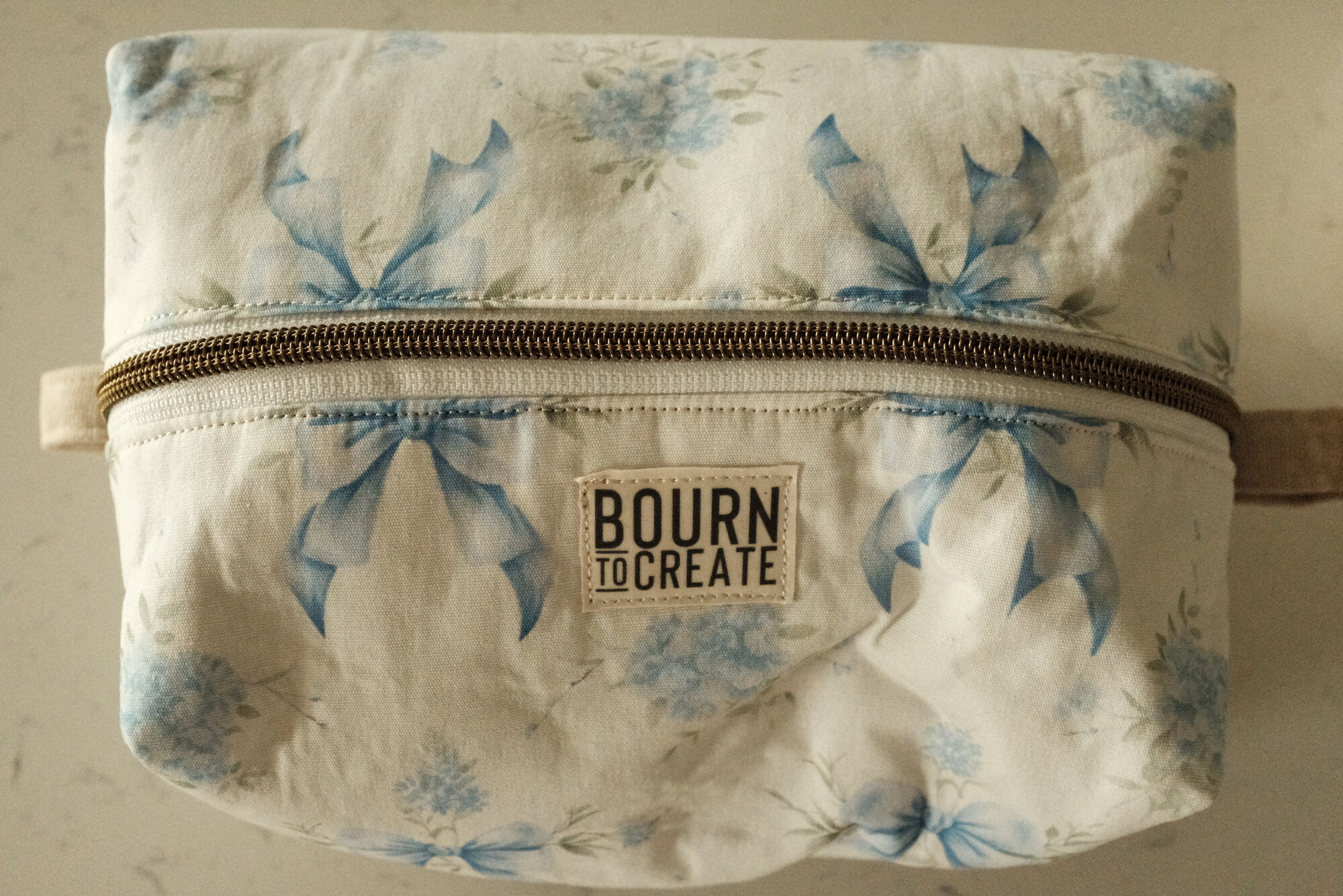 Boxy zip makeup bag in a blue floral print