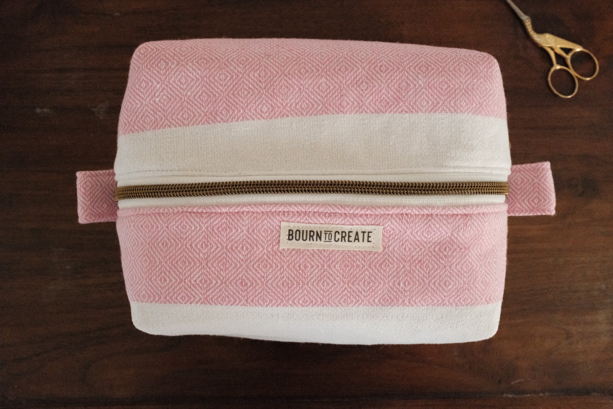 Boxy zip makeup bag in a soft pink diamond weave