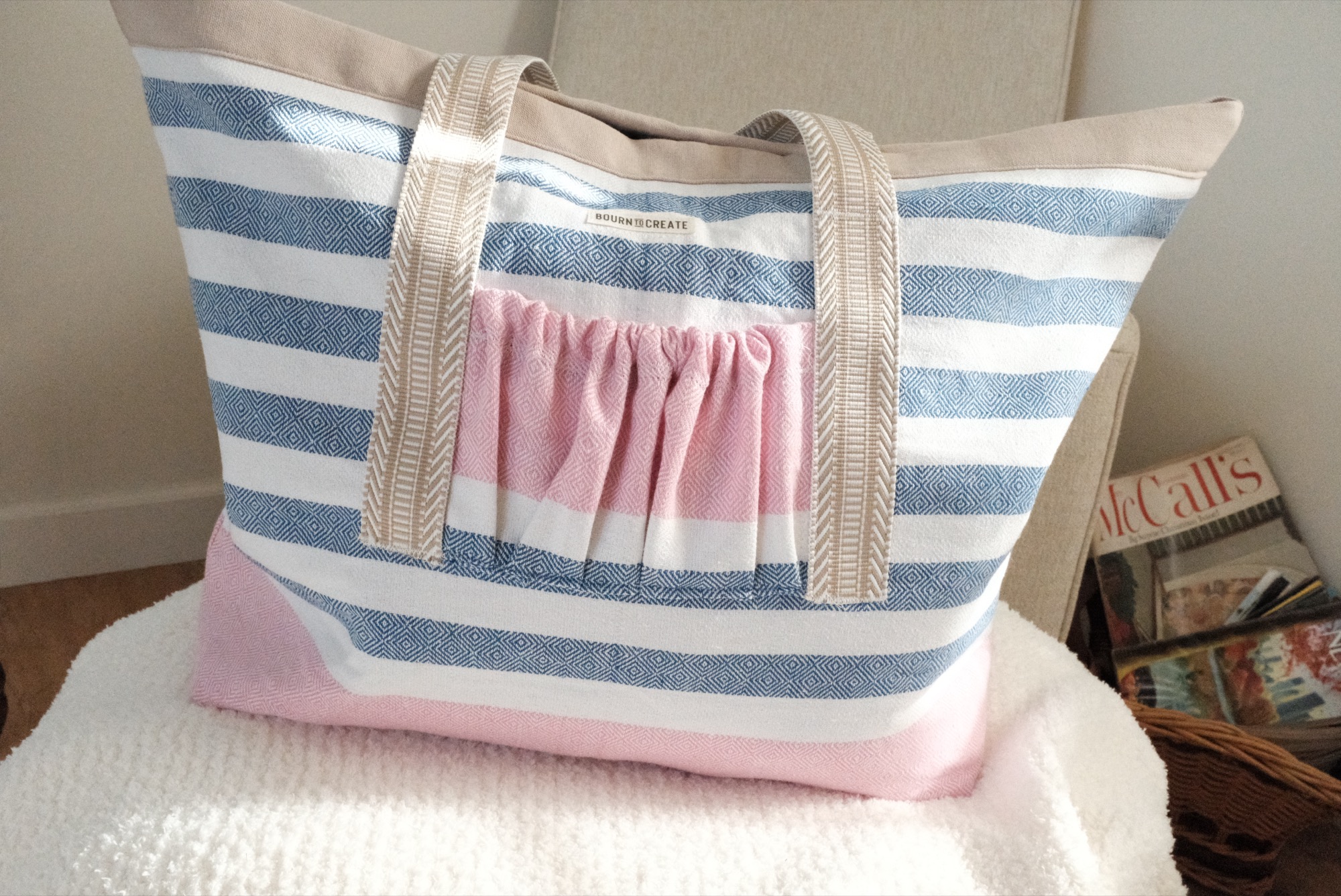The seaside tote in blue-and-blush stripe with a gathered pocket, handmade in Biloxi