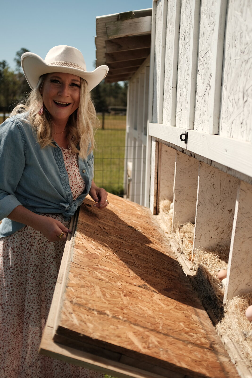 Sarah at the chicken coop, mid-laugh