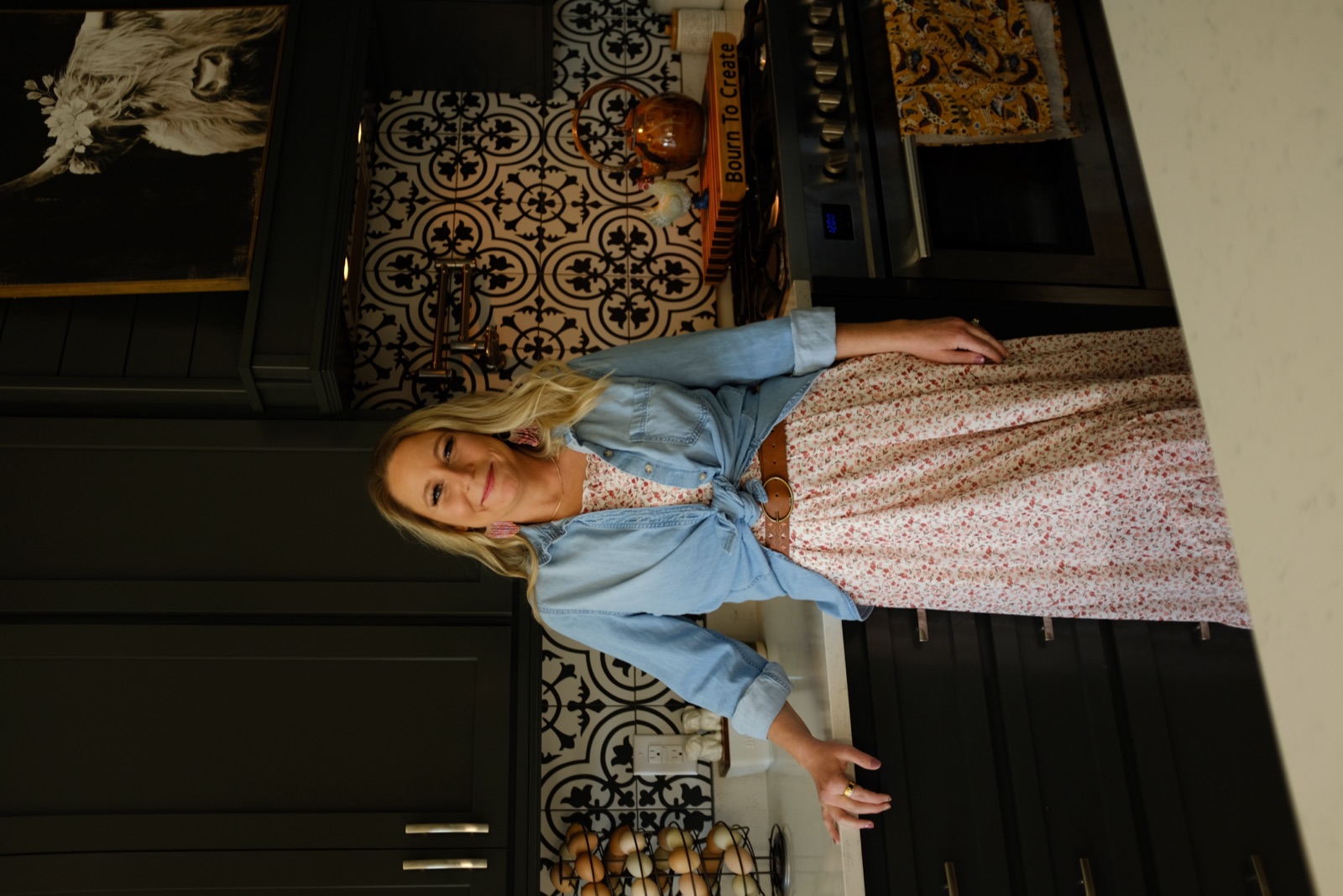 Sarah in her kitchen, Bourn to Create board on the stove