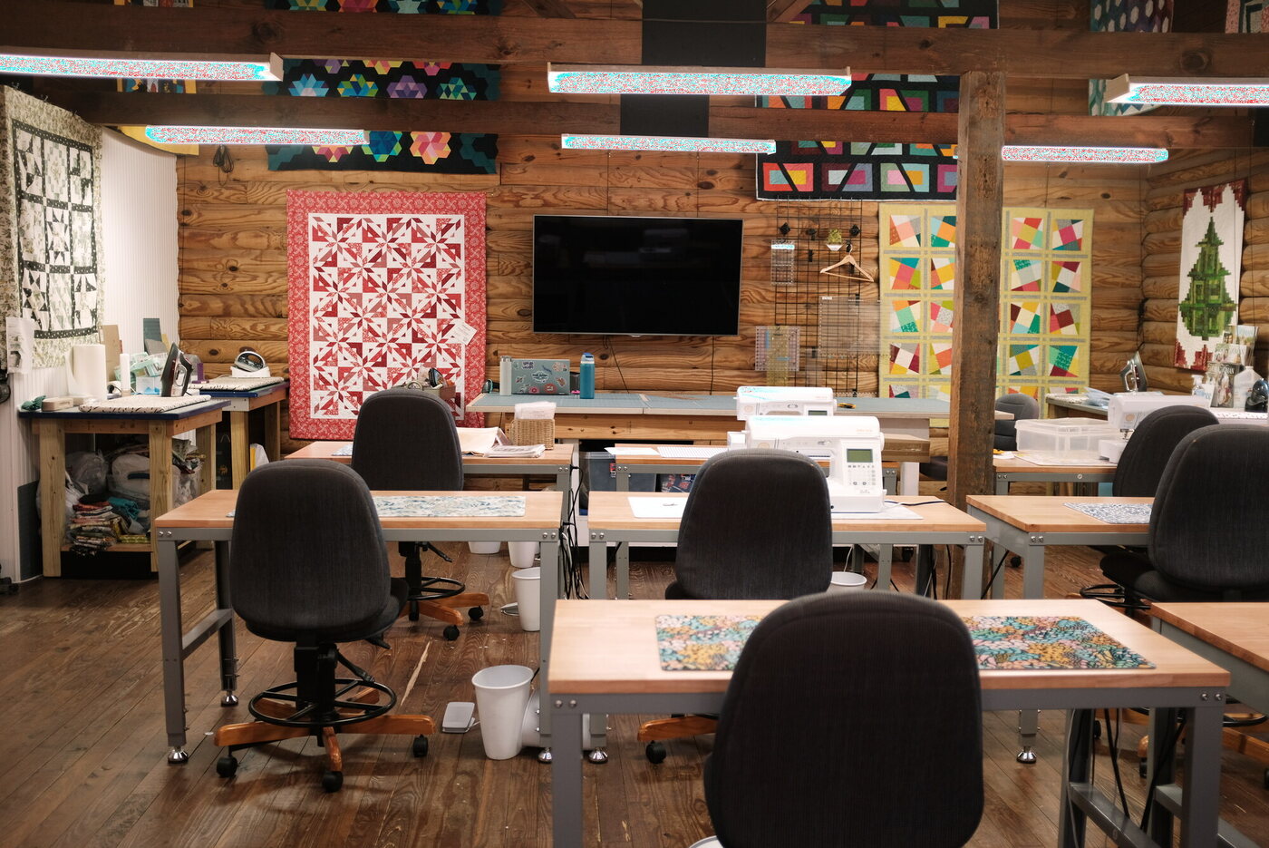 A quilting classroom, machines set at every table
